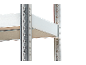 Metal shelves of a shelving unit with perforated uprights against a black background.