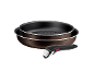 Stackable brown frying pans with detachable handles on a black background.
