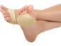 Beige foot pads on crossed feet against a black background.