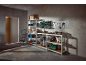 Garage or workshop with shelving units, tools, storage boxes, and a vacuum cleaner.