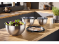 Stainless steel mixing bowls with lids, one filled with salad, on a kitchen counter.