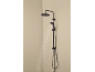 Black shower system with a rain shower and a hand shower, from which water flows.