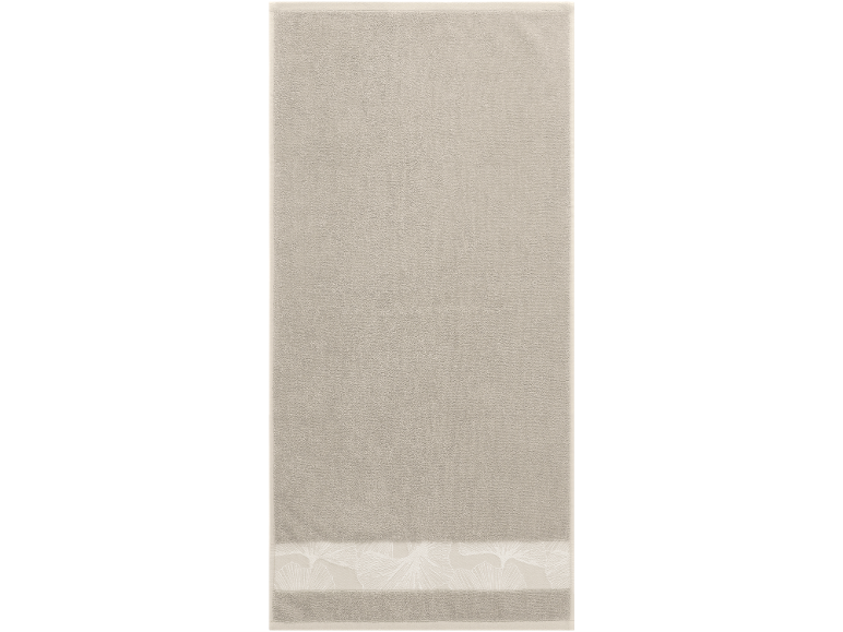Beige hand towel with a decorative leaf pattern on the bottom border.