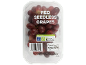Red seedless grapes in a clear plastic container, with nutritional and recycling information.