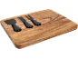 Wooden cheese board with three black-handled cheese knives.