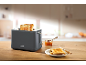Toaster with crispy toast, jam, and knife on a wooden table.
