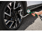 Tire pressure gauge with manometer attached to a car tire.
