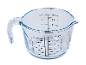 Glass measuring jug with handle, with markings in milliliters, liters, ounces, and pints.