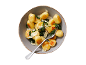 Gnocchi with spinach and Parmesan cheese in a bowl, one cut open showing the filling.