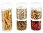 Clear containers with pasta, oats, granola, hazelnuts, and dried strawberries.