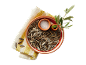 Roasted sunflower seeds with salt and an olive branch on a kitchen towel.