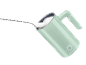 Mint green milk frother with a spoon of foam.