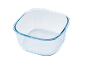 Transparent square glass container with rounded edges.