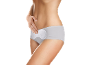 Woman in briefs with an incontinence pad, hand on abdomen.