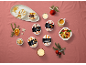 Coffee, hazelnut, peach, vanilla, banana, and caramel ice cream desserts in a Christmas setting.