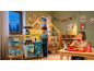 Kids playing with a toy kitchen and a fast food play set in a cozy room.