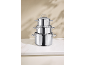 Stainless steel pot set, stacked on top of each other, on a white countertop.