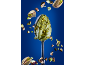Spoon with pistachio cream and floating pistachios against a blue background.