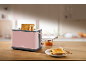 Pink toaster with toast, jam, and a knife on a wooden table.
