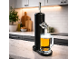 Black beer dispenser with a beer mug on a kitchen countertop.
