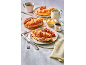 Breakfast with ham and cheese croissants, cherry tomatoes, coffee, and butter.