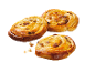 Three golden, glossy raisin swirls on a black background.