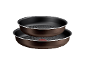 Two brown non-stick frying pans with dotted bottoms, stacked on top of each other.