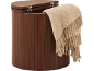 Wooden laundry hamper with an open lid and a beige throw blanket.
