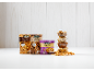 Assortment of nuts: packaged walnuts, almonds, and cashews, plus bowls of nuts.