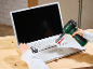 Cordless blower cleaning a laptop keyboard, with a fork in the other hand.
