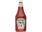 A large bottle of tomato ketchup with a white label, featuring a tomato and the text 'GROWN NOT MADE'.