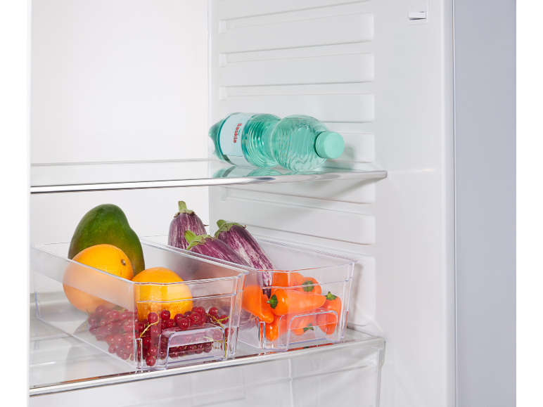 Refrigerator with water bottles and clear containers filled with fruits and vegetables.