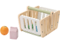 Wooden shopping basket with an orange and a grape juice carton.