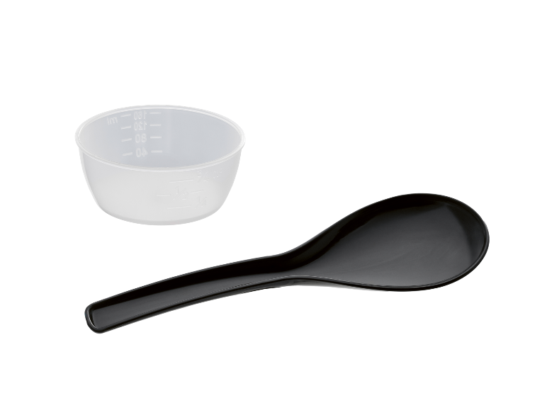 Translucent measuring cup and black serving spoon on a black background.