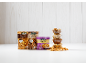 Assortment of nuts: packaged walnuts, almonds, and cashews, plus bowls of nuts.