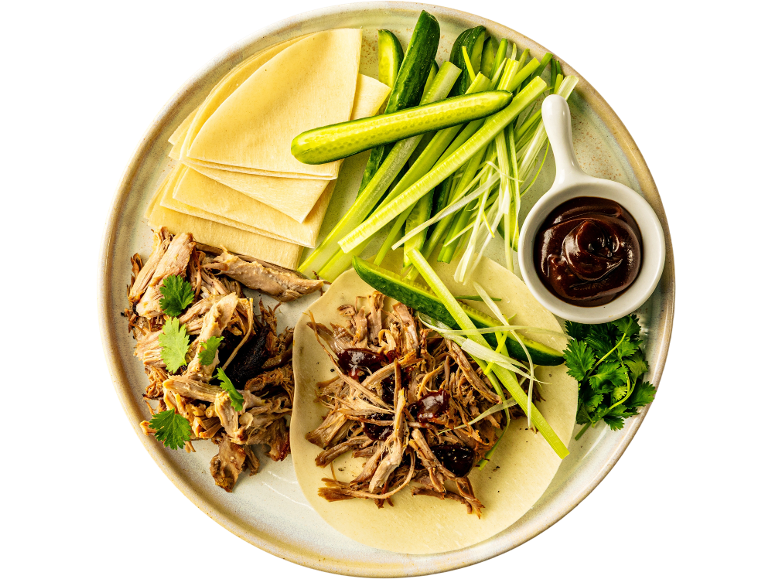 Peking duck style pulled duck with pancakes, cucumber, spring onion, and hoisin sauce.