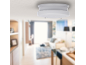 Smoke detector on the ceiling in a modern living room.