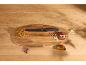Black bread knife on a wooden cutting board with toast and onion.