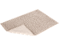 Beige bath mat with a raised corner, showing the non-slip backing.