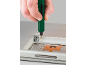 A green electric screwdriver is used to repair a laptop.