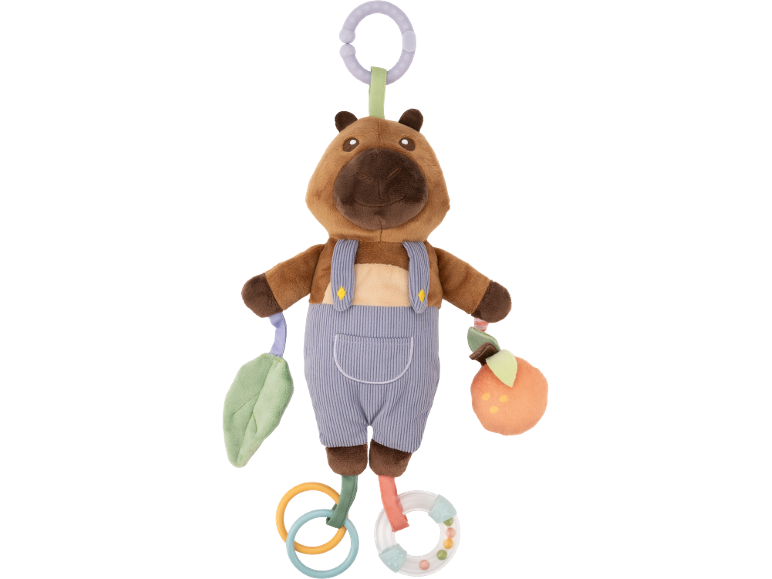 Plush capybara toy in overalls with a leaf and an orange, with teething rings.