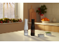 Black and white spice grinders on a kitchen table in a festive setting.