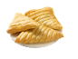 Three golden puff pastry turnovers on a white plate