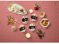 Festive arrangement with four mini ice cream desserts and a cup of coffee.