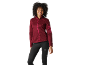 Woman in a maroon sports jacket and black leggings.