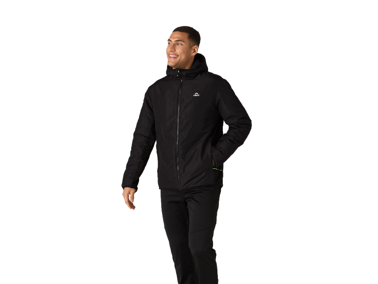 Man in black sports jacket and trousers, smiling and looking to the right.
