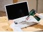 Person cleaning a laptop keyboard with a heat gun and a fork.