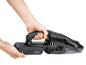 Black cordless handheld vacuum cleaner with removable battery being inserted.