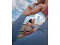 Two women in sports leggings and tops doing yoga outdoors.