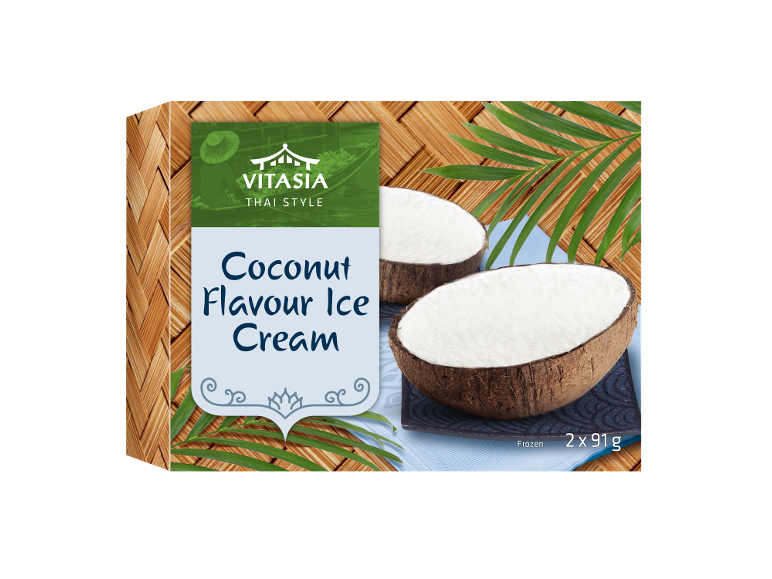 Coconut flavour ice cream in coconut halves, with palm leaves and a bamboo background.